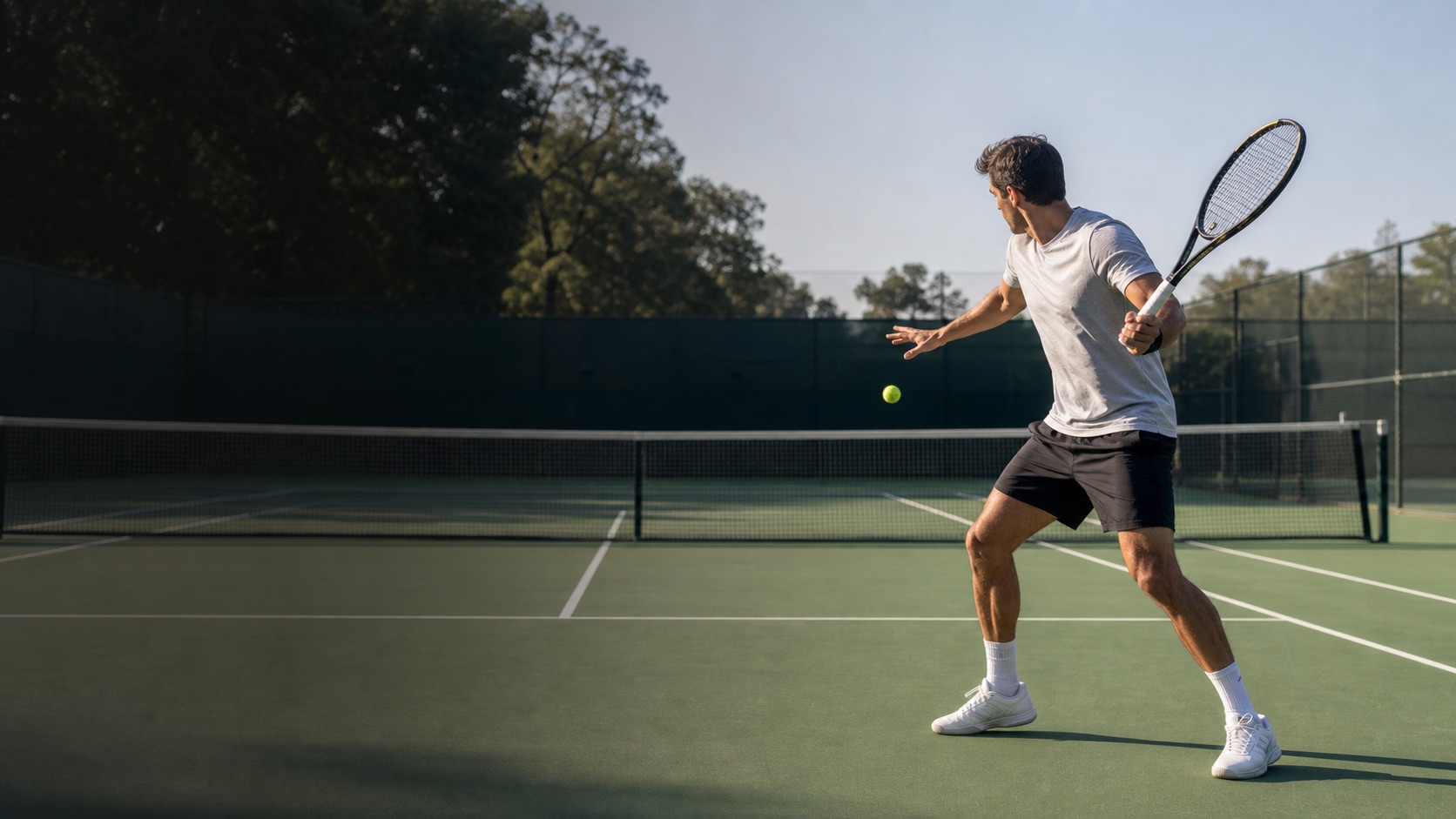A tennis player preparing a forehand on an outdoor court